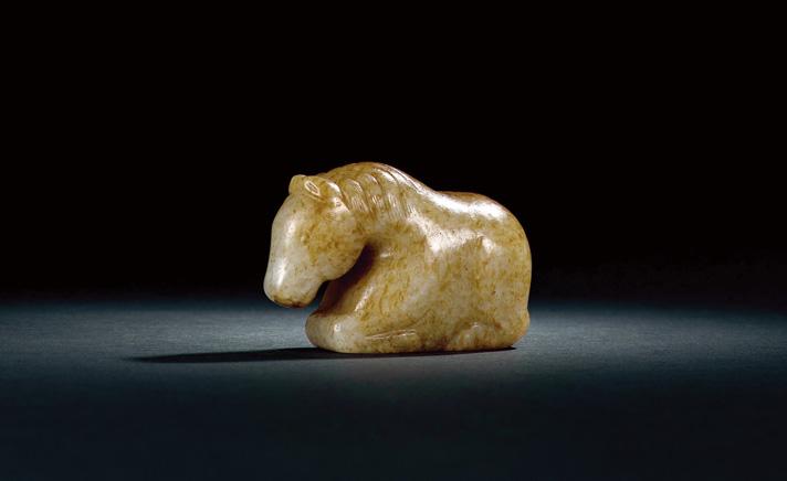 1354 A RUSSET AND CELADON JADE CARVING OF A HORSE Song Dynasty (AD