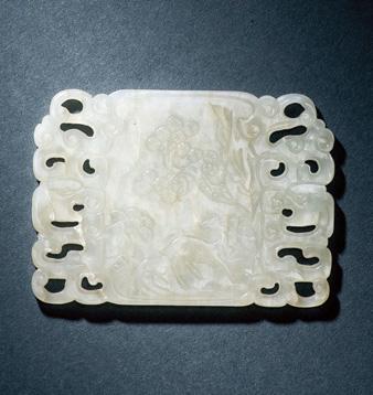 1437 A WHITE JADE PLAQUE Qing Dynasty, 18th Century 7.5 cm.