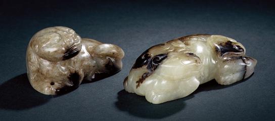 1174 TWO JADE FIGURES OF RECUMBENT PIGS Song Dynasty (AD 960-1279) The largest, 4.5 cm. (1 3 /4 in.