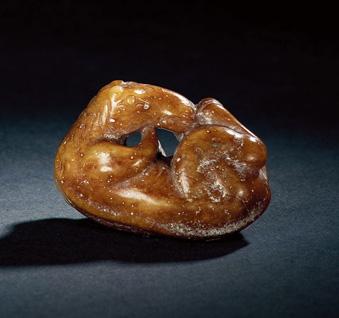 1196 A RUSSET JADE FIGURE OF A FROLICKING HORSE Ming Dynasty (1368-1644) 4.4 cm. (1 3 /4 in.